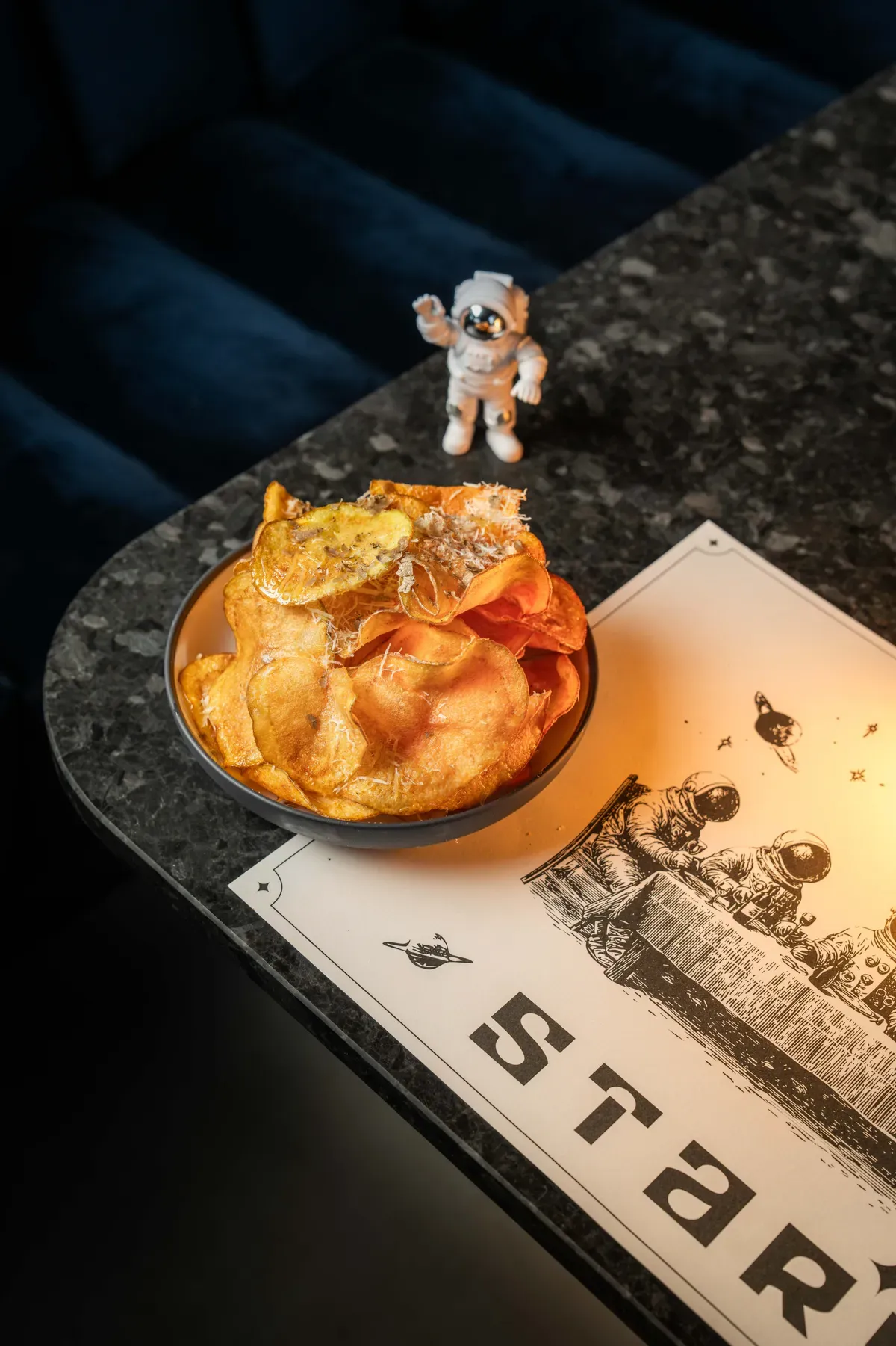 Homemade potato chips with truffle and Grana Padano
